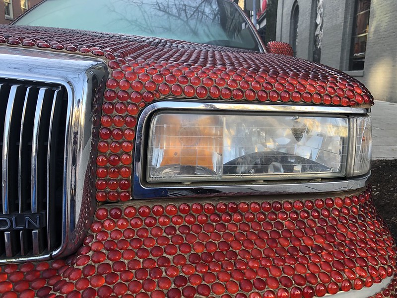 Front of a car covered in red rhinestones